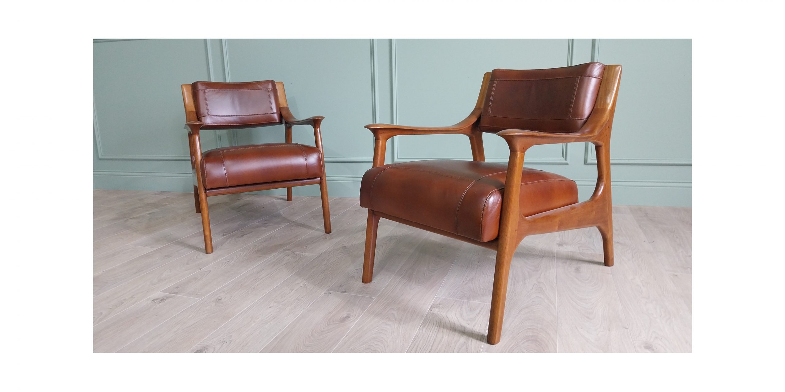Pair of cherrywood and hand dyed leather open arm chairs